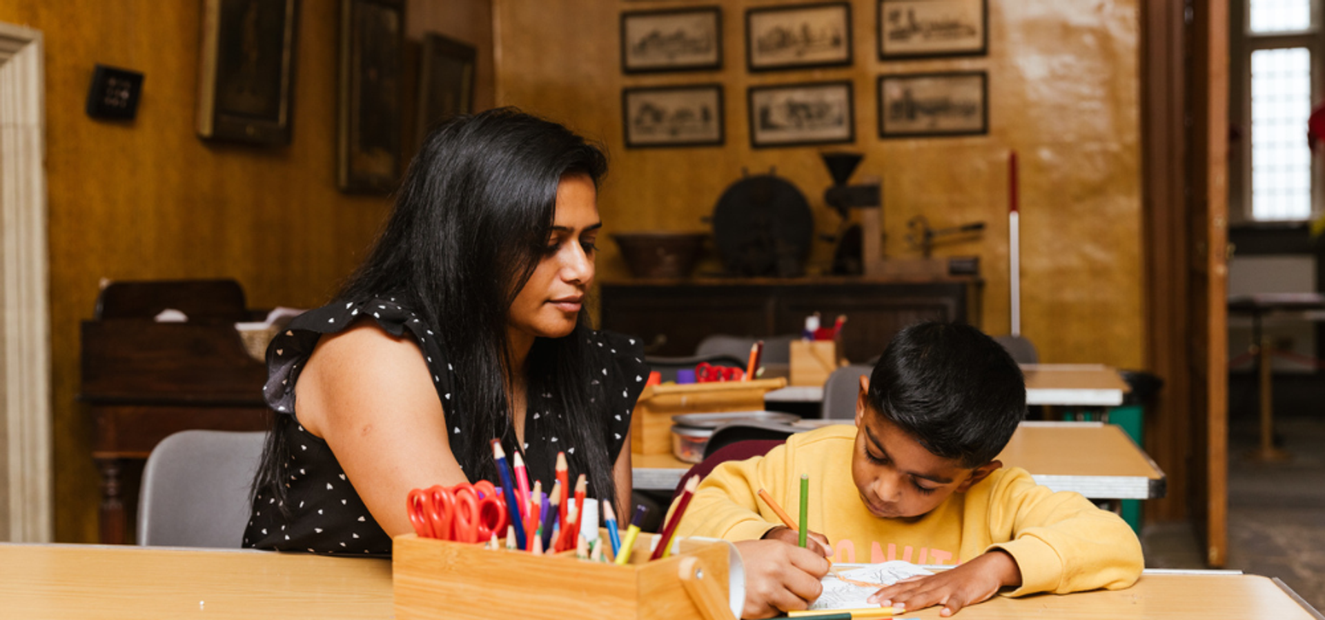 Adult and child doing colouring activity int he craft space at Temple Newsam