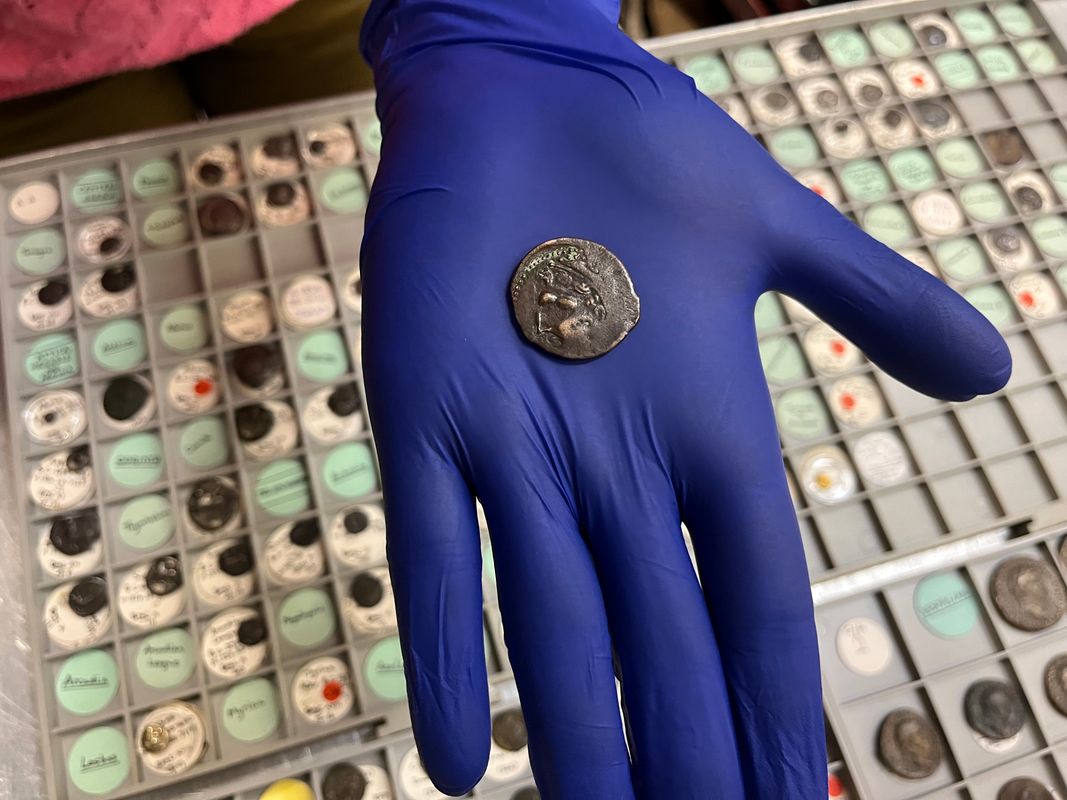 on one side the coin bears the face of the god Melqart, resembling the Greek hero Herakles and wearing his famed lionskin headdress. At that time, some Phoenician coins carried Greek imagery to make them more appealing to traders.